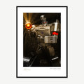 Framed print: macro of a robot action figure firing its weapon, black wood frame