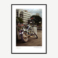 Framed print: custom chopper motorcycle with tall handlebars parked on a street, black wood frame