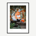 Framed print: alley mural of a figure holding a tiger cub with ivy, black wood frame