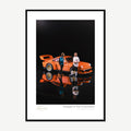 Framed print: miniature figures beside an orange classic car model, black wood frame