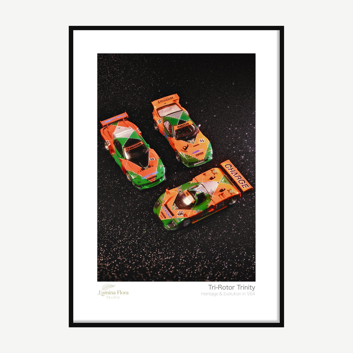 Framed print: three 1/64 rotary race car models in matching livery, black wood frame