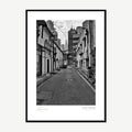 Framed print: black and white alleyway with a distant tower spire, black wood frame
