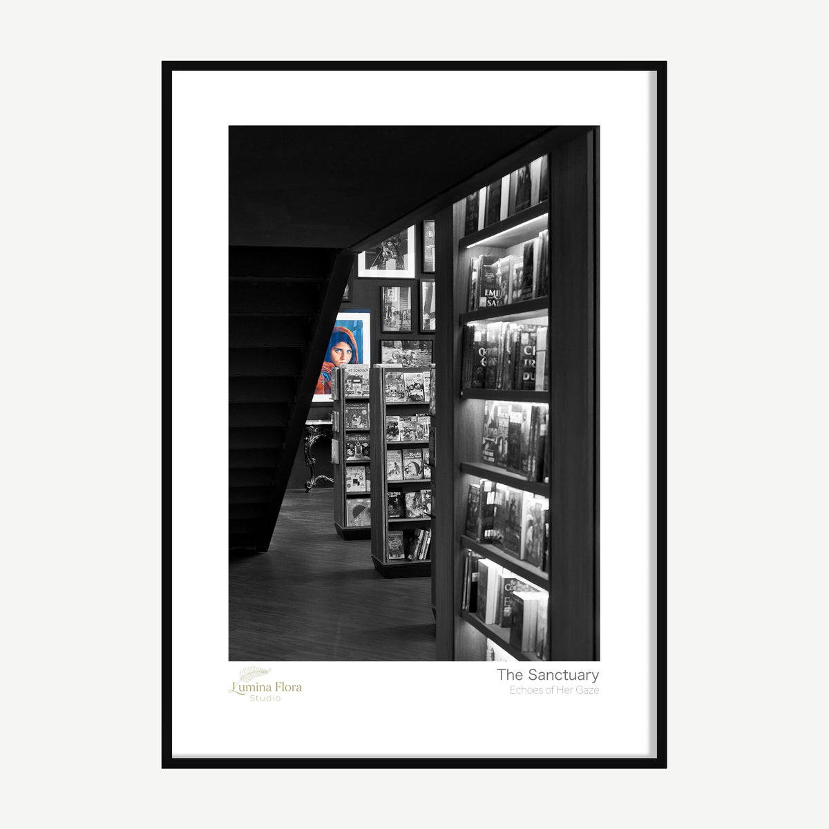 Framed print: dim bookshop interior with shelves and stairs in selective colour, black wood frame