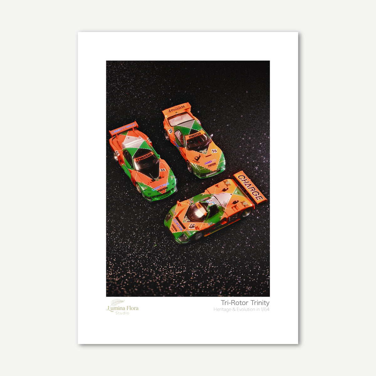 Unframed print: three 1/64 rotary race car models, white gallery border